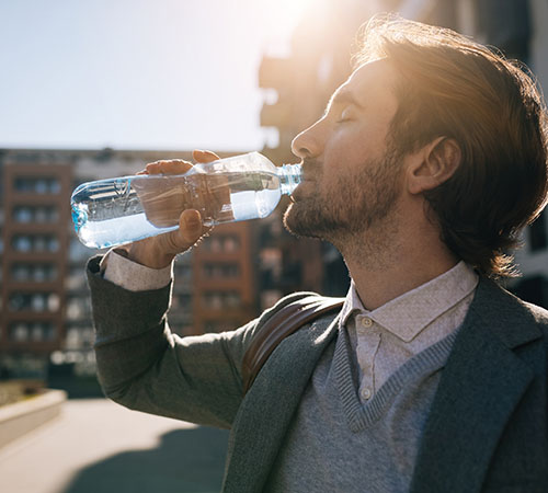 Young man drinking water